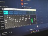 Close-up of a digital audio graphic equalizer on a laptop screen for music editing.
