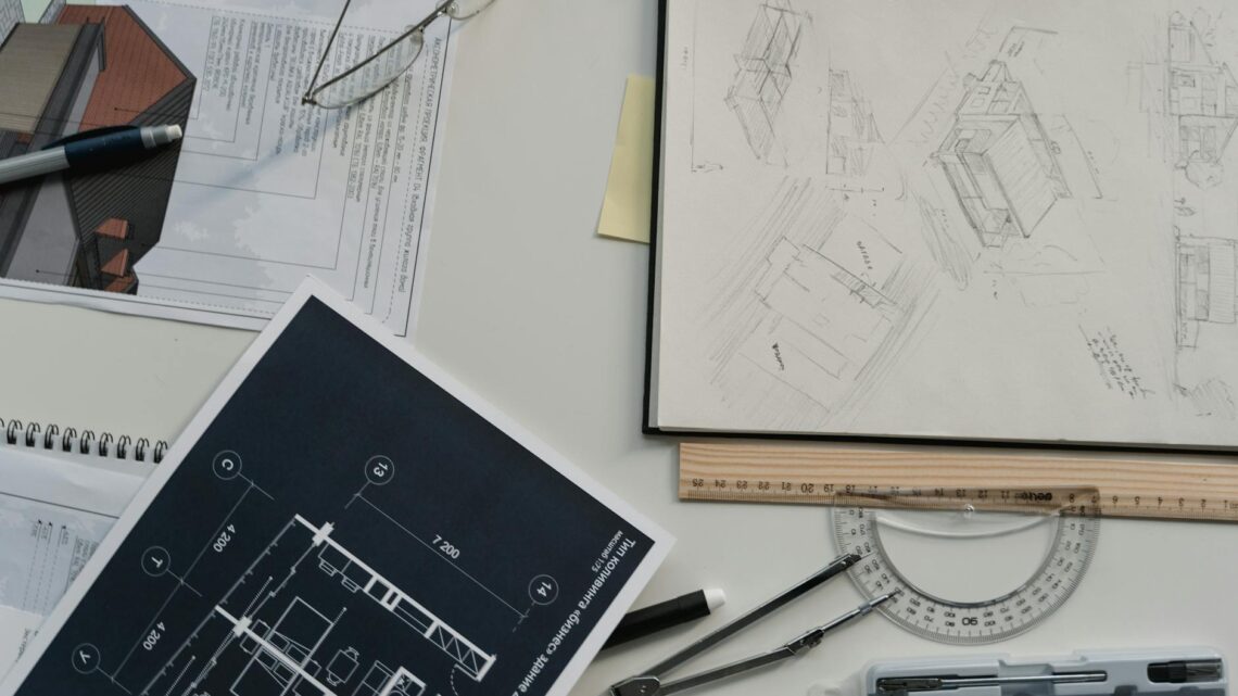Creative workspace with architectural sketches, blueprints, and drawing tools, perfect for planning and design.