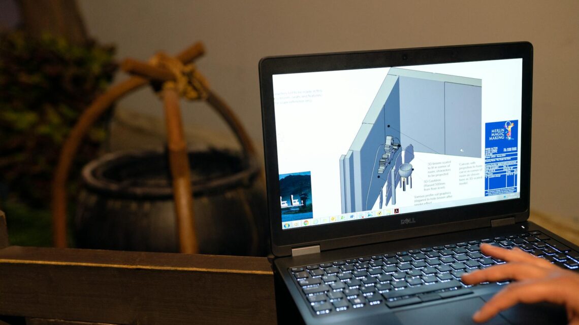 Engineer working on a CAD design using a laptop computer. Indoor setting highlighting technology in engineering.