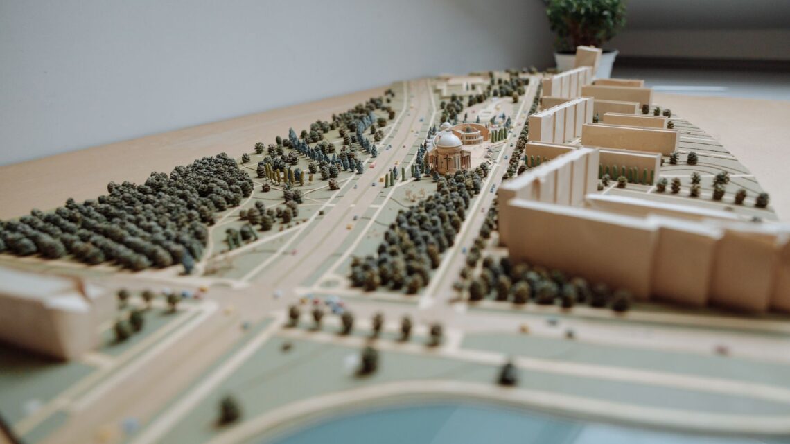 Close-up of an architectural miniature model depicting an urban layout with buildings, roads, and greenery.