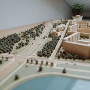 Close-up of an architectural miniature model depicting an urban layout with buildings, roads, and greenery.