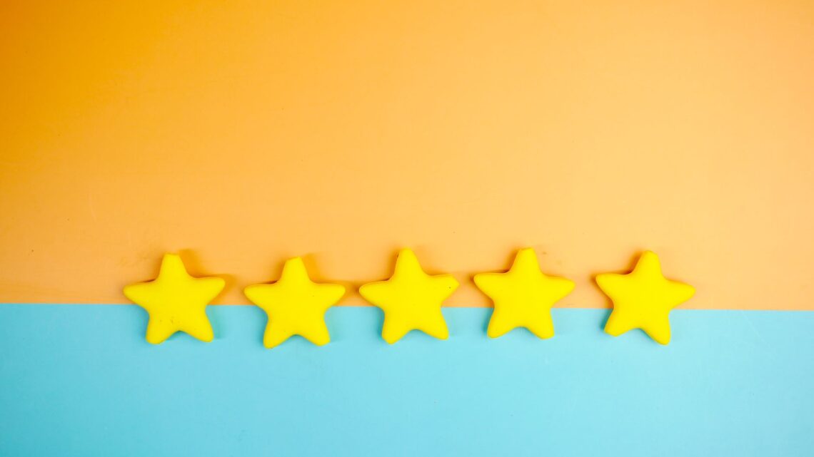 Bright yellow stars arranged on a vivid orange and blue background with copy space.