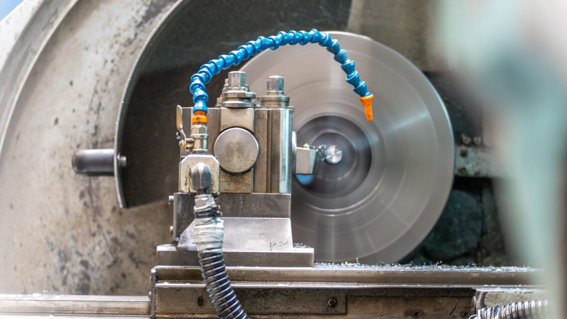 Close-up of a spinning lathe machine in an industrial workshop setting.