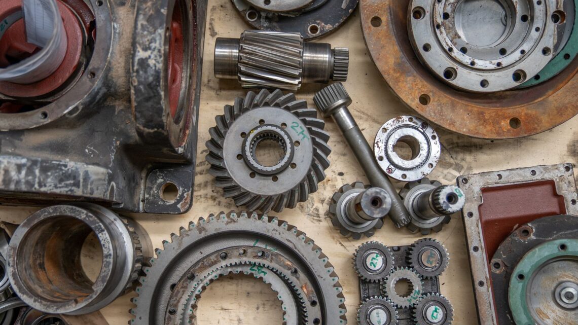Detailed shot of industrial gears and mechanical parts in a workshop setting.