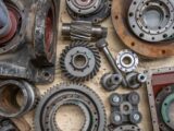 Detailed shot of industrial gears and mechanical parts in a workshop setting.