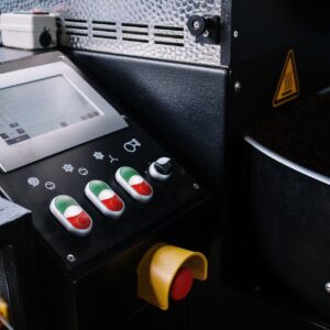 Detailed view of a coffee roaster control panel showing buttons and beans.