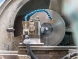 Close-up of a spinning lathe machine in an industrial workshop setting.