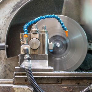 Close-up of a spinning lathe machine in an industrial workshop setting.
