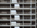 Close-up of a multi-storey building under construction, showcasing steel and concrete structure.