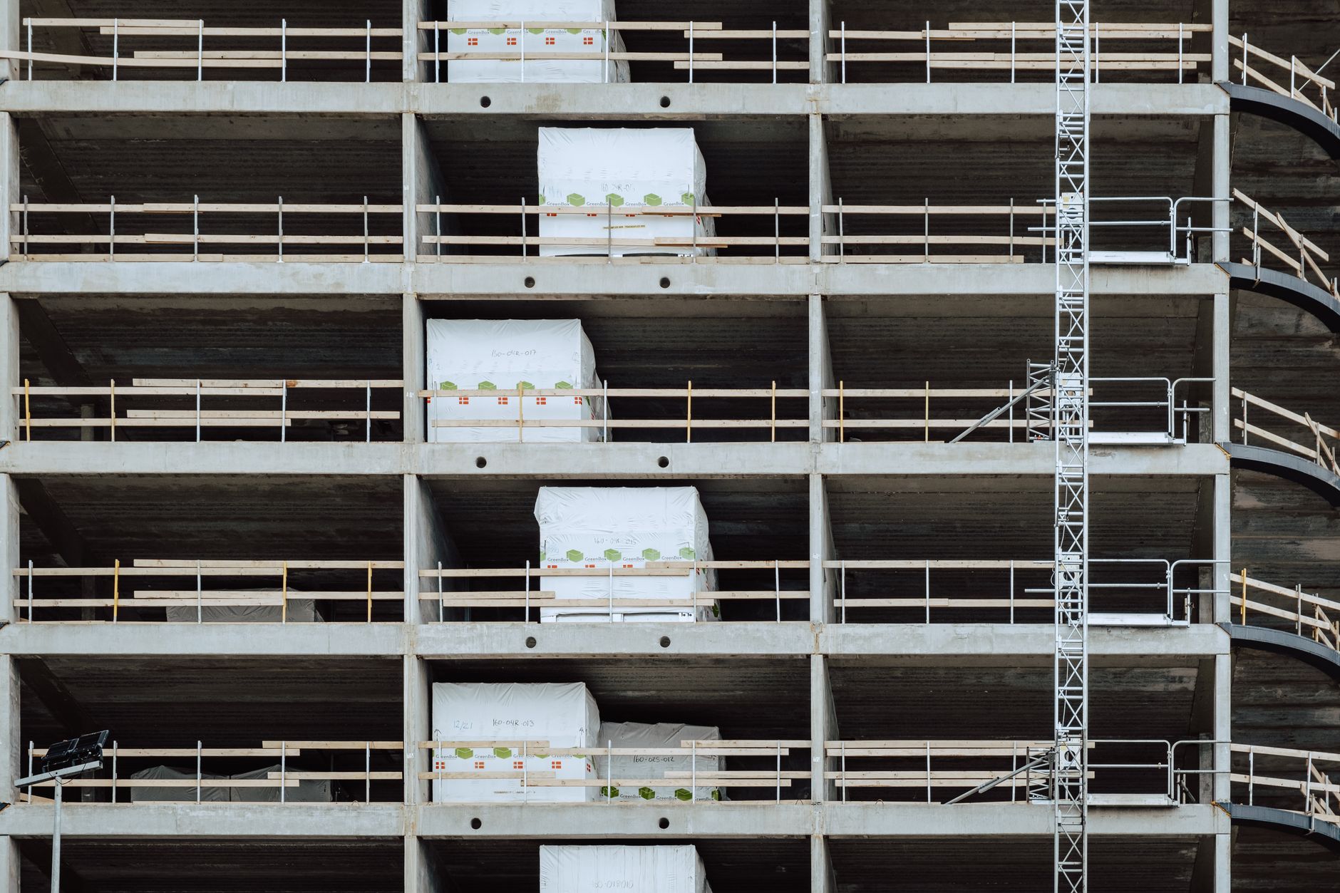 Close-up of a multi-storey building under construction, showcasing steel and concrete structure.