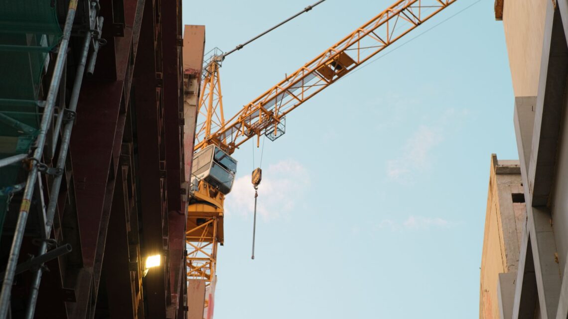 A construction crane dominates the urban skyline of Bratislava, Slovakia.