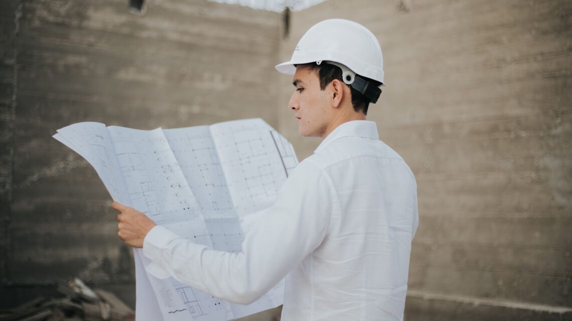 Architect examining blueprints at a construction site in Mexico.