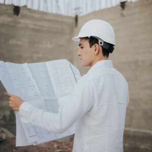 Architect examining blueprints at a construction site in Mexico.