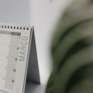 A close-up shot of a desk calendar open on March, with a soft, minimalistic background.