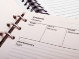 Open planner displaying project schedule with Russian-English text, ideal for office or educational content.