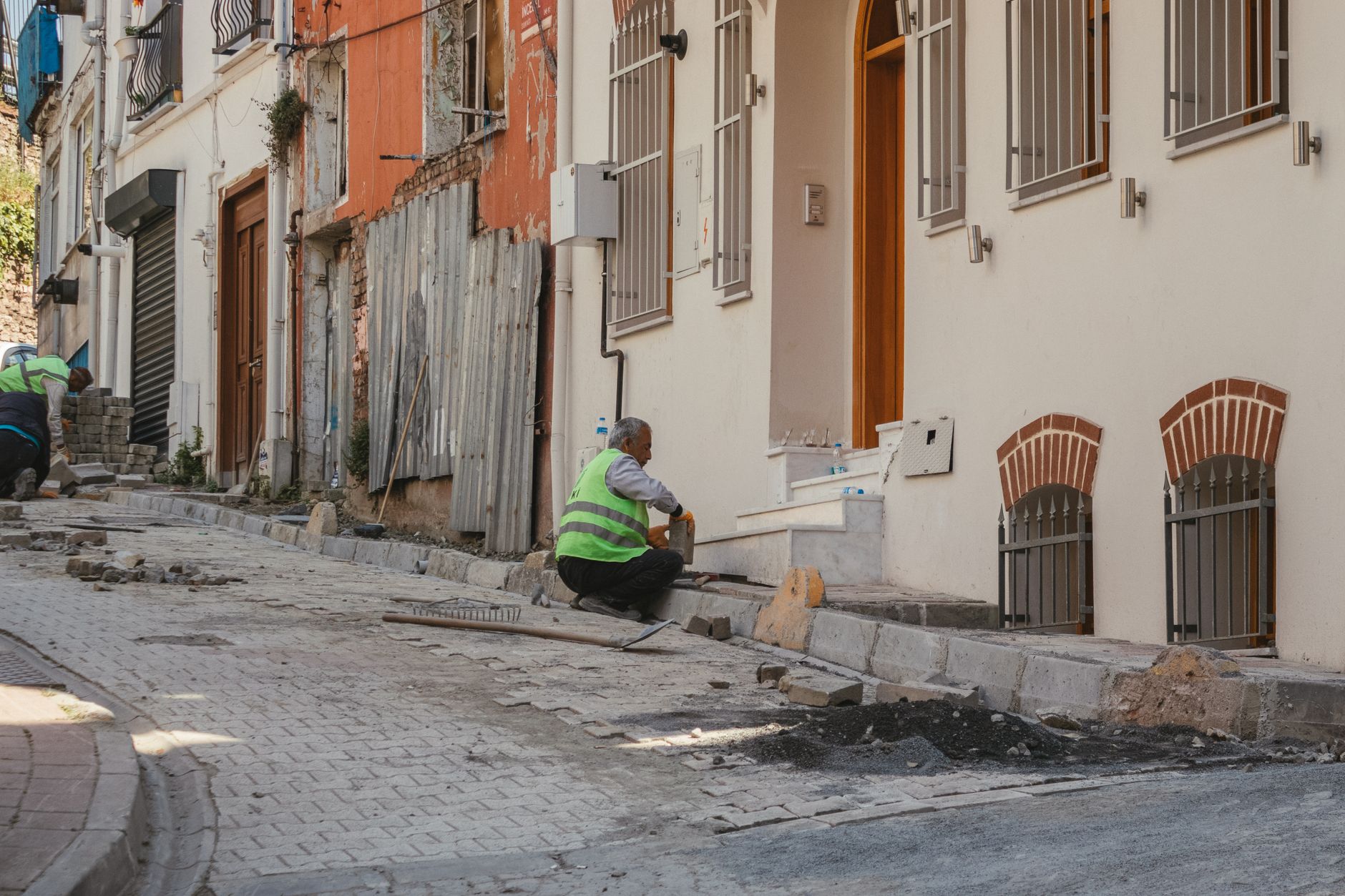 Construction workers repairing an urban street, showcasing teamwork and hard work.