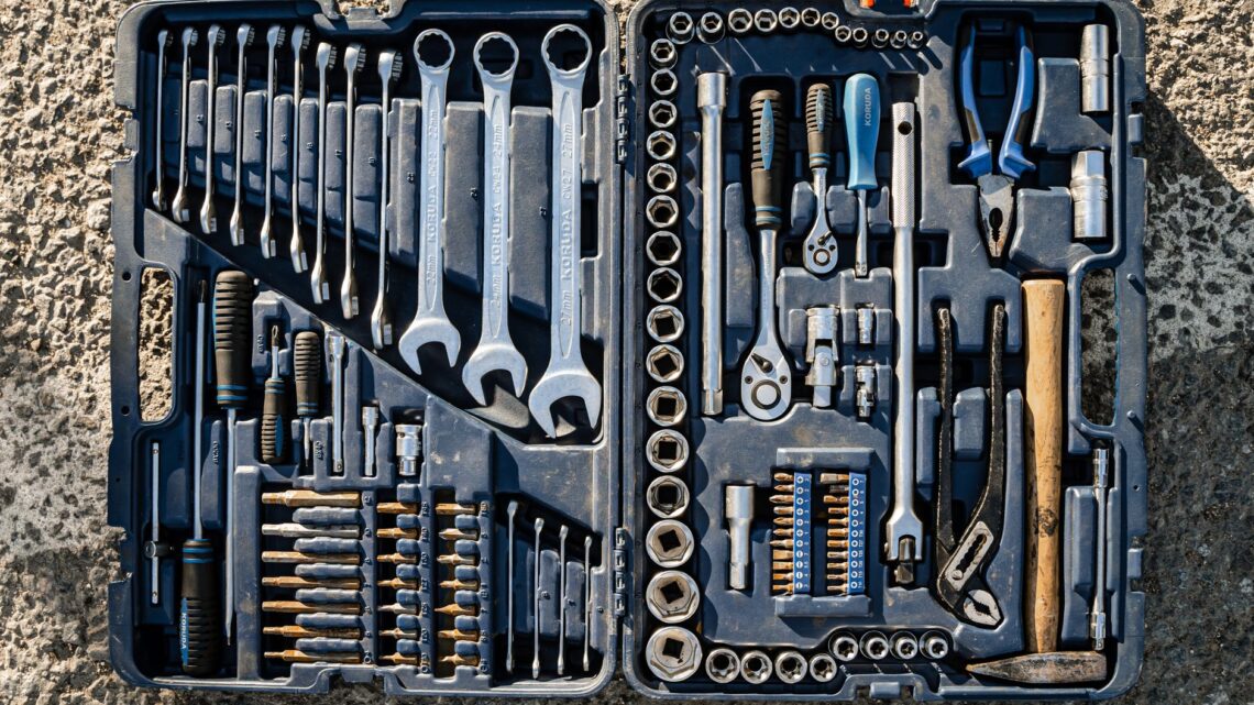 Flat lay of an organized toolbox with a variety of essential hand tools.