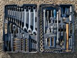Flat lay of an organized toolbox with a variety of essential hand tools.