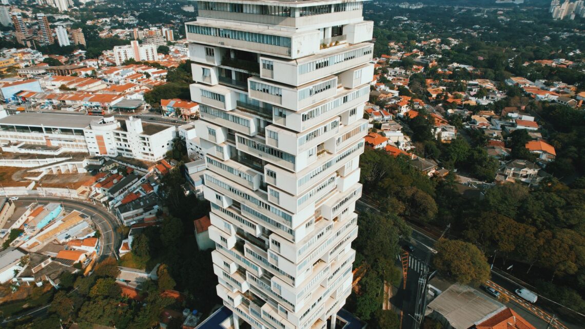 Aerial shot of a modern architectural tower standing amidst the cityscape of São Paulo, Brazil.
