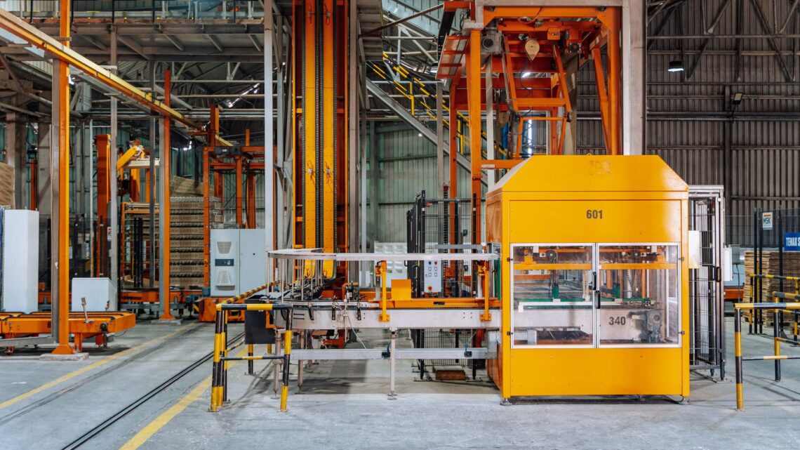 Detailed view of machinery in an operational glass factory in Dar es Salaam.