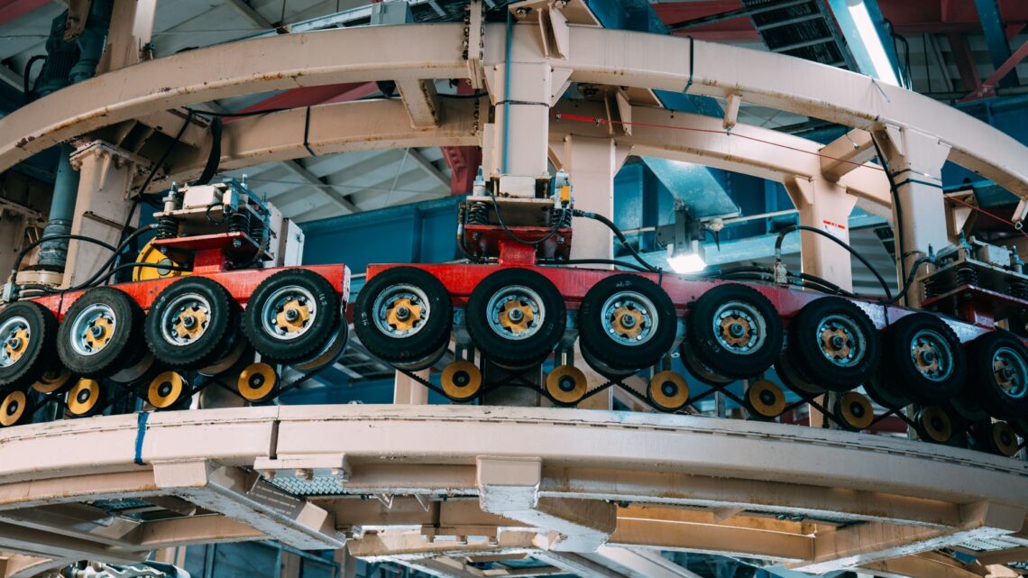 Close-up view of a complex industrial conveyor system inside a manufacturing facility.