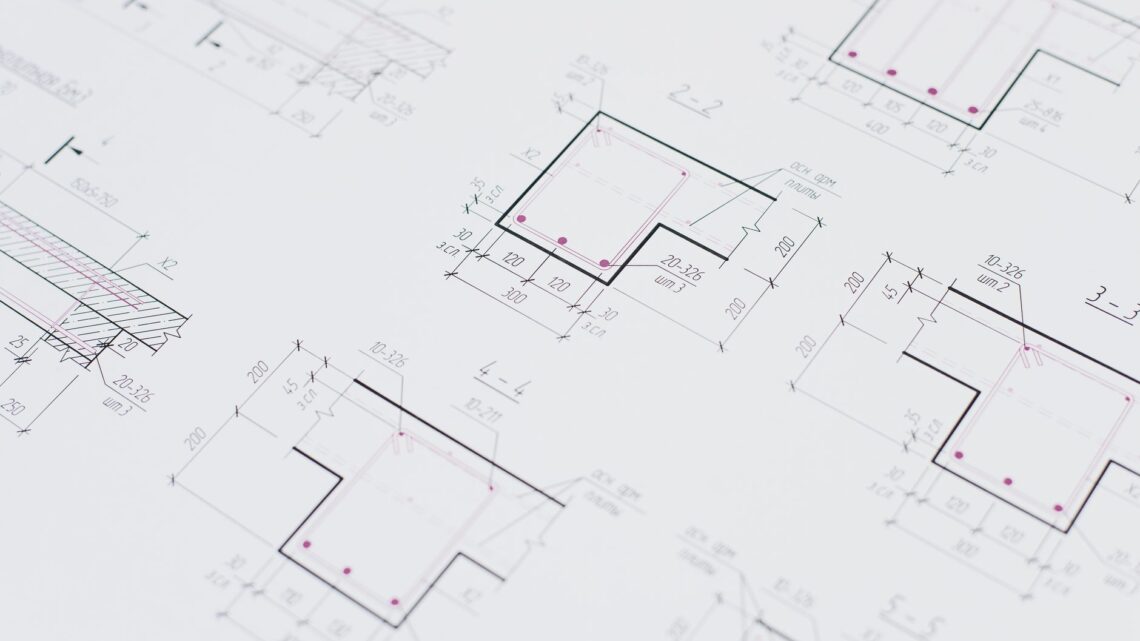 High-resolution close-up of detailed architectural blueprints showcasing precision design layouts.