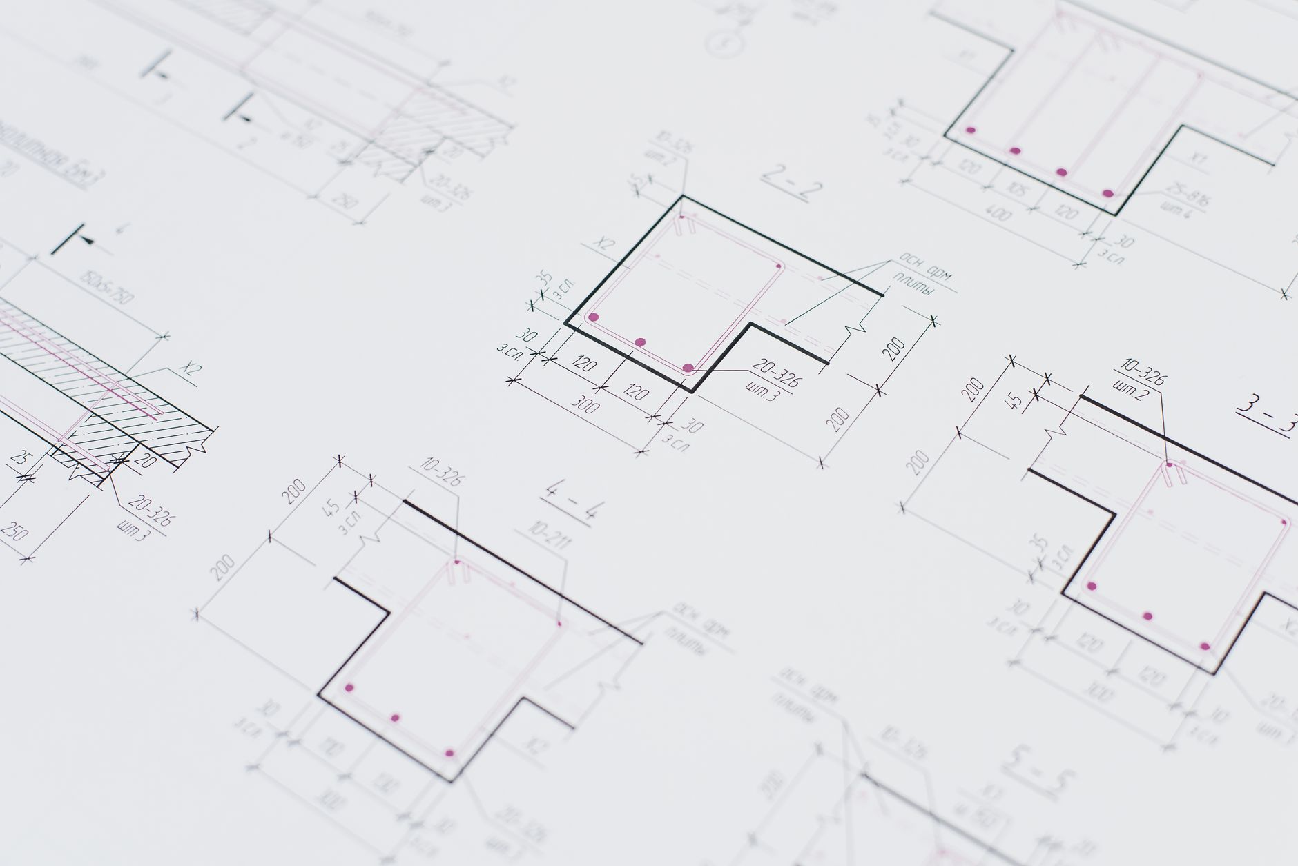 High-resolution close-up of detailed architectural blueprints showcasing precision design layouts.