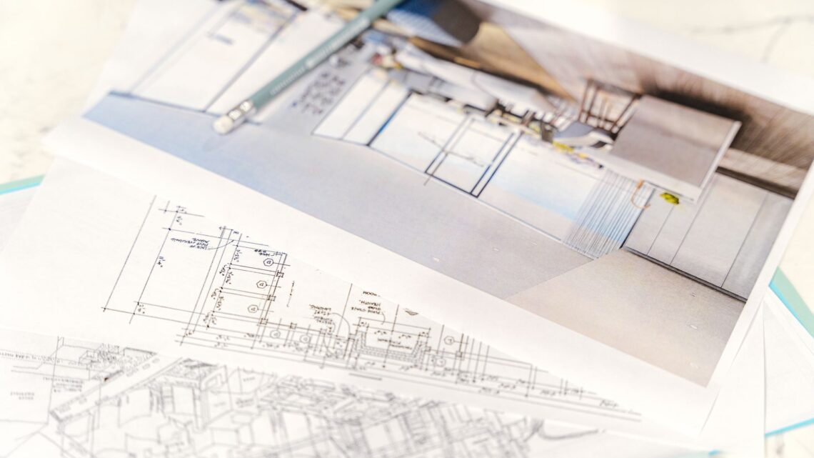 Close-up of architectural blueprints and 3D design on paper with pencil on a desk.