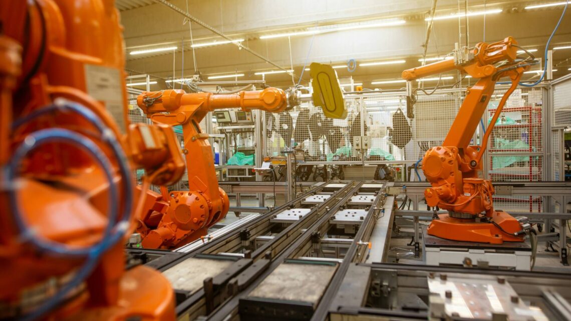a factory filled with lots of orange machines